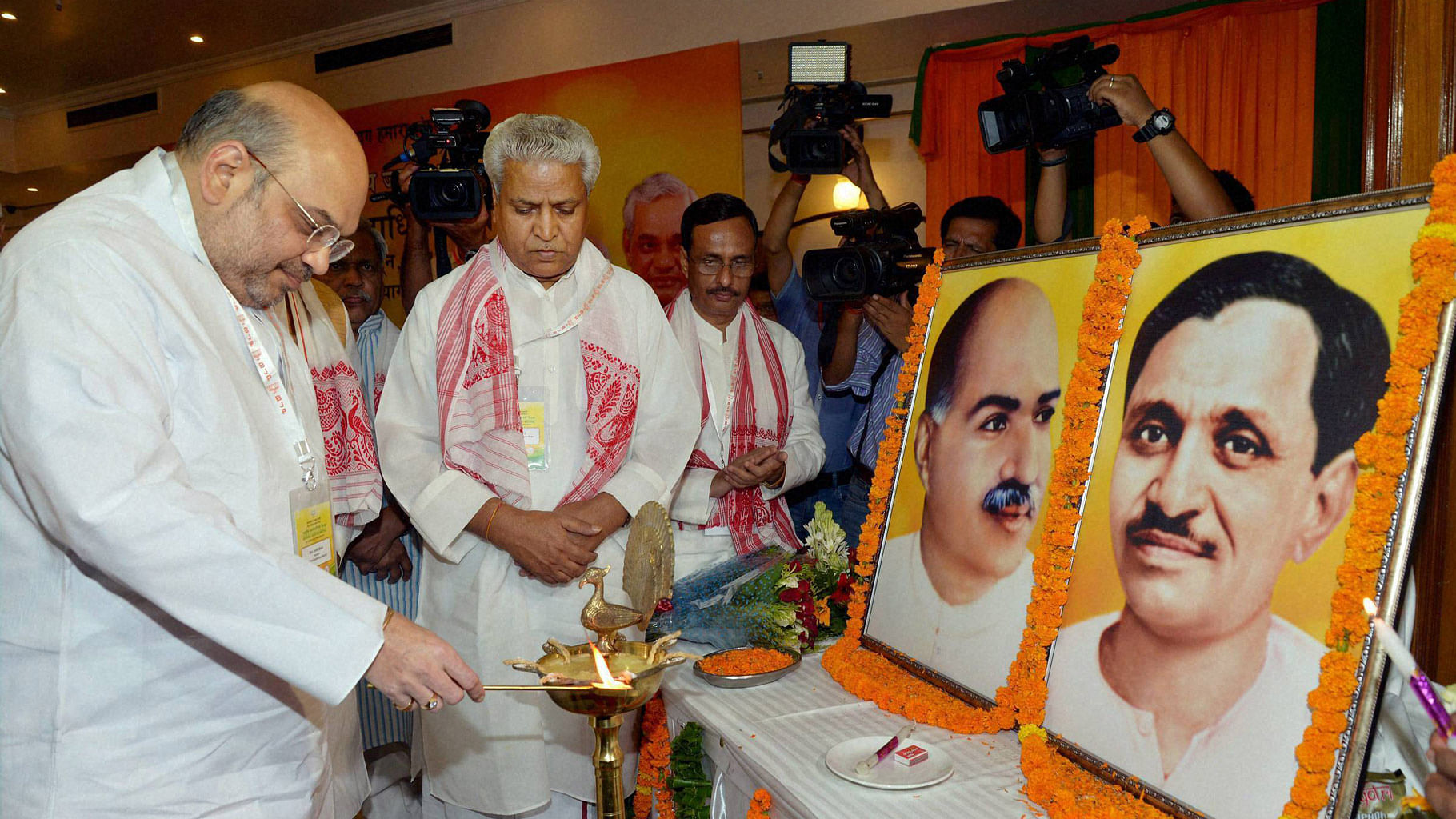

BJP National President Amit Shah lighting the lamp to inaugurate BJP’s national executive meeting in Allahabad, 12 June  2016. (Photo: PTI)