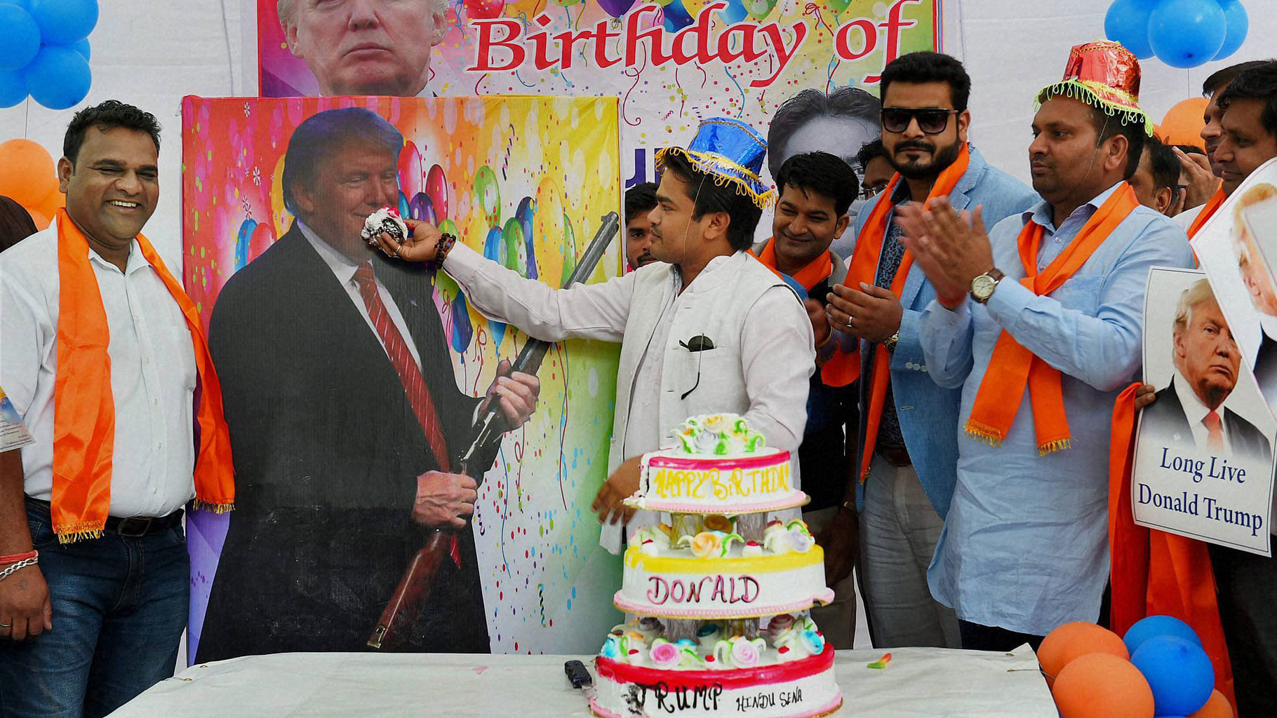 President of Hindu Sena cut the cake to celebrate birthday of Donald Trump. (Photo: PTI)