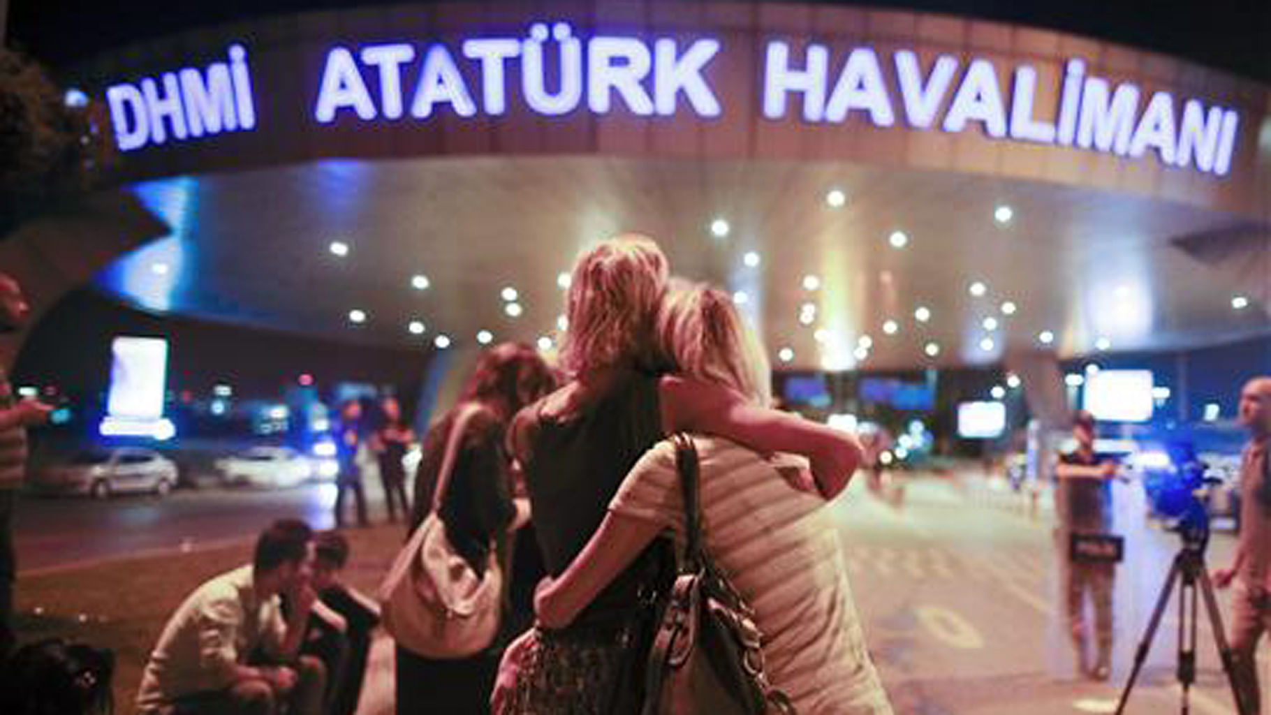 Passengers embrace each other at the entrance to Istanbul’s Ataturk airport, early Wednesday, June 29, 2016 following their evacuation after a blast. (Photo: AP)