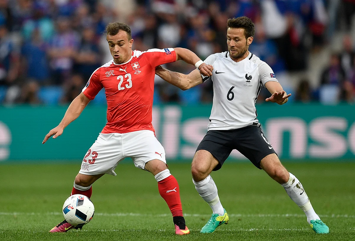 Switzerland’s Xherdan Shaqiri, left, fights for the ball with France’s Yohan Cabaye during their group match. (Photo: AP) 