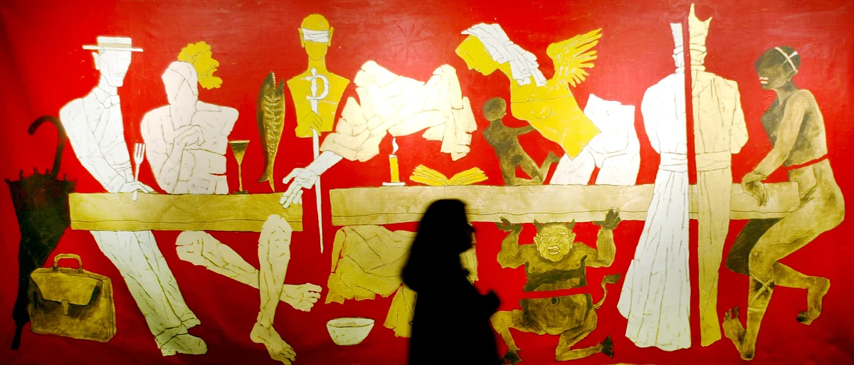 A visitor looks at a painting by MF Husain during an exhibition in Mumbai. 
