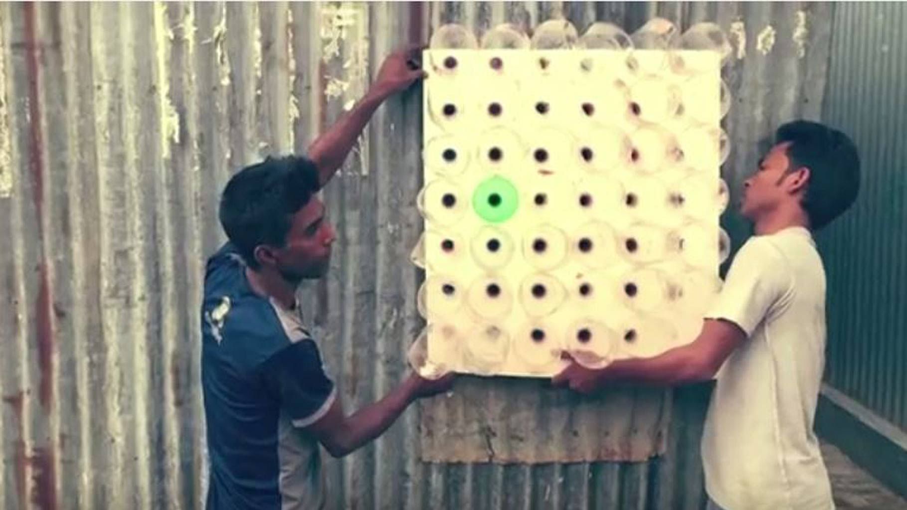 People mounting an Eco Cooler on a vent. (Photo Courtesy: YouTube Screengrab)