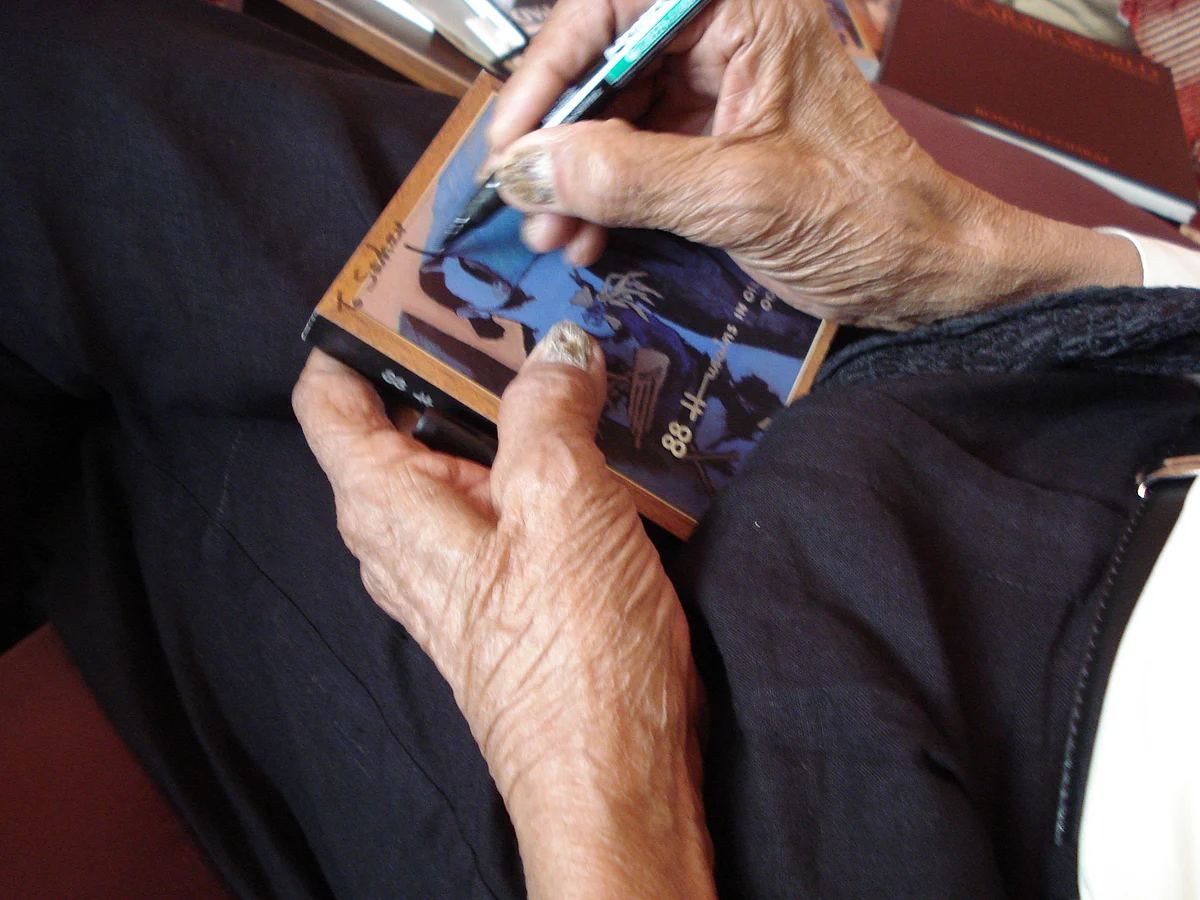 MF Husain signs a poster for me. 