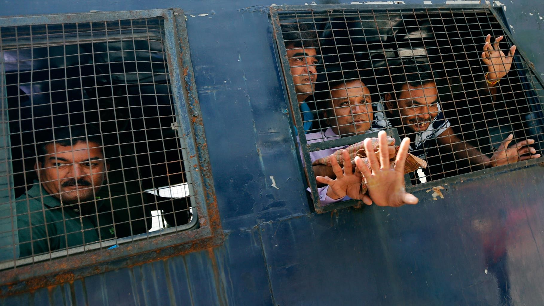 Convicts in the Gulbarg massacre case being taken away in a police van in Ahmadabad, on Thursday, 9 June 2016. (Photo: AP)