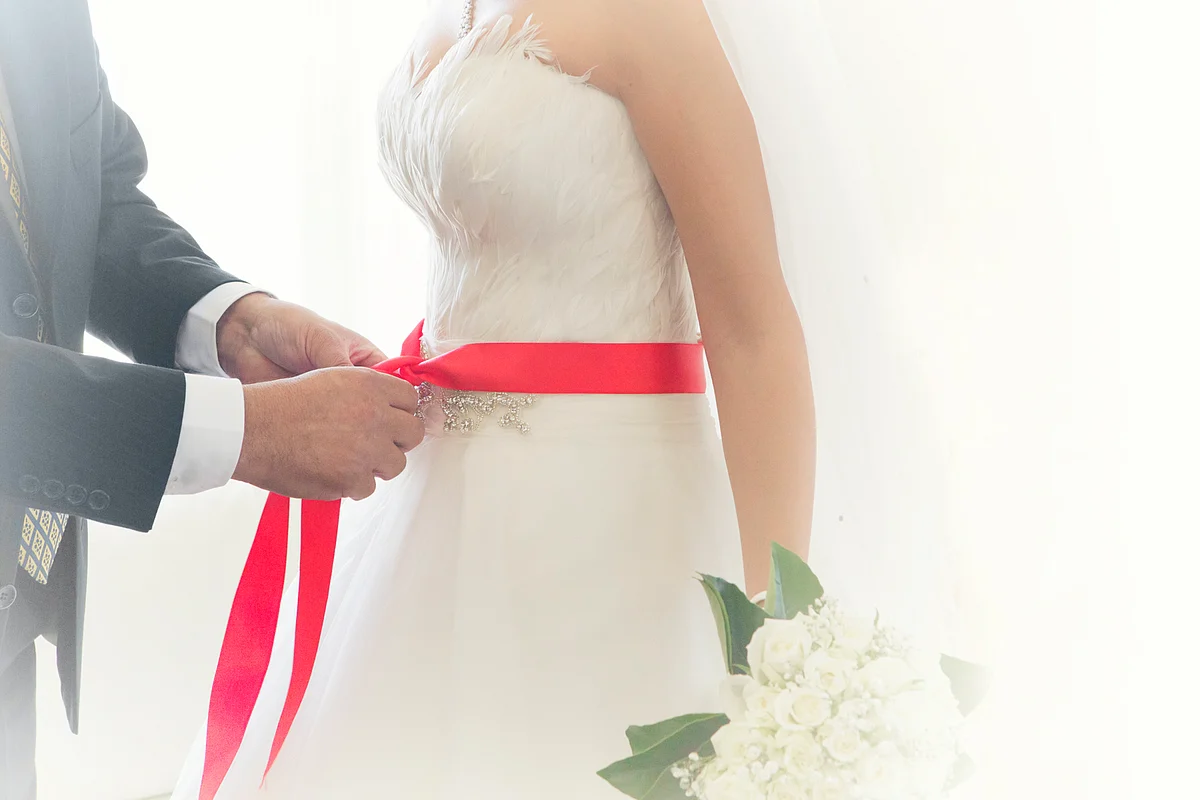 The red ribbon signifies the bride’s virginity in traditional Turkish weddings. (Photo: iStockphoto)