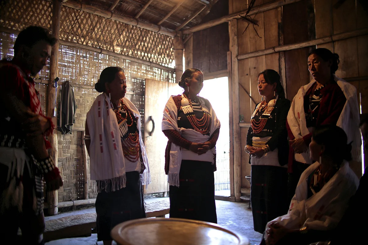Members of the Rengma tribe sing a traditional song sung by mothers when her sons leave for battle, in their ‘Morong’ at the annual Hornbill Festival. (Photo: Souvid Datta)