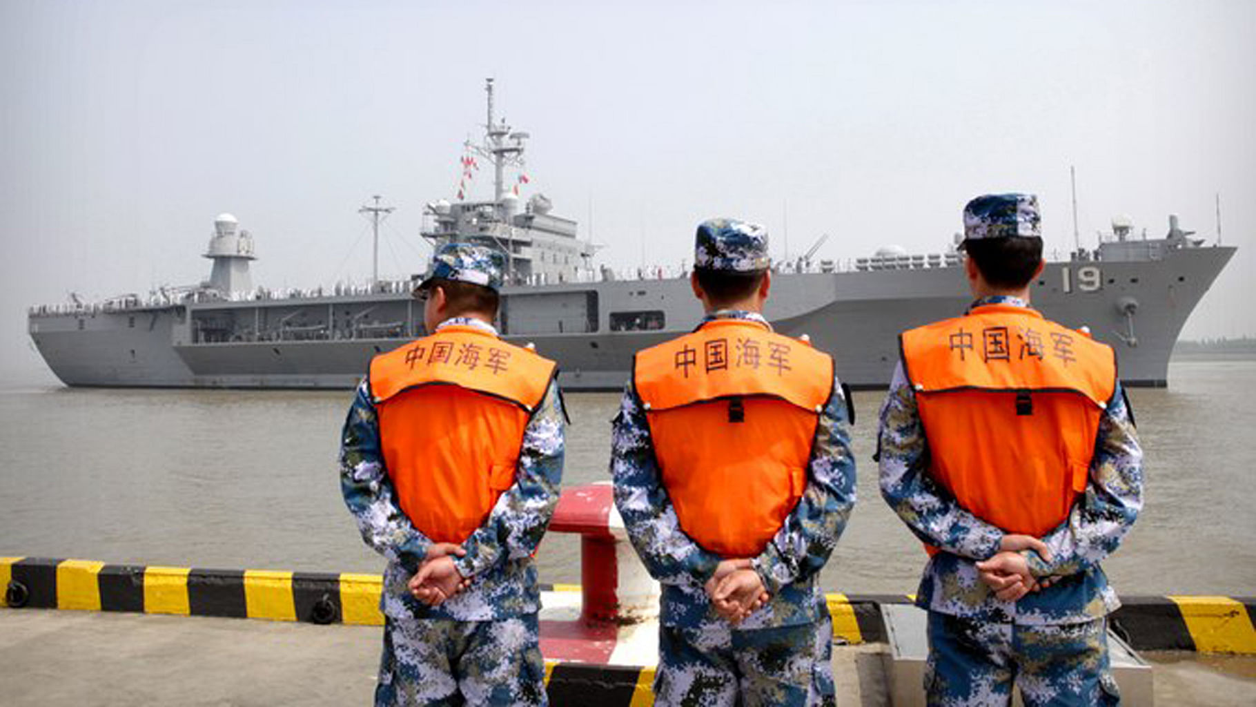 

File photo of soldiers from the Chinese People’s Liberation Army (PLA) Navy watching the USS Blue Ridge arrive at a port in Shanghai.