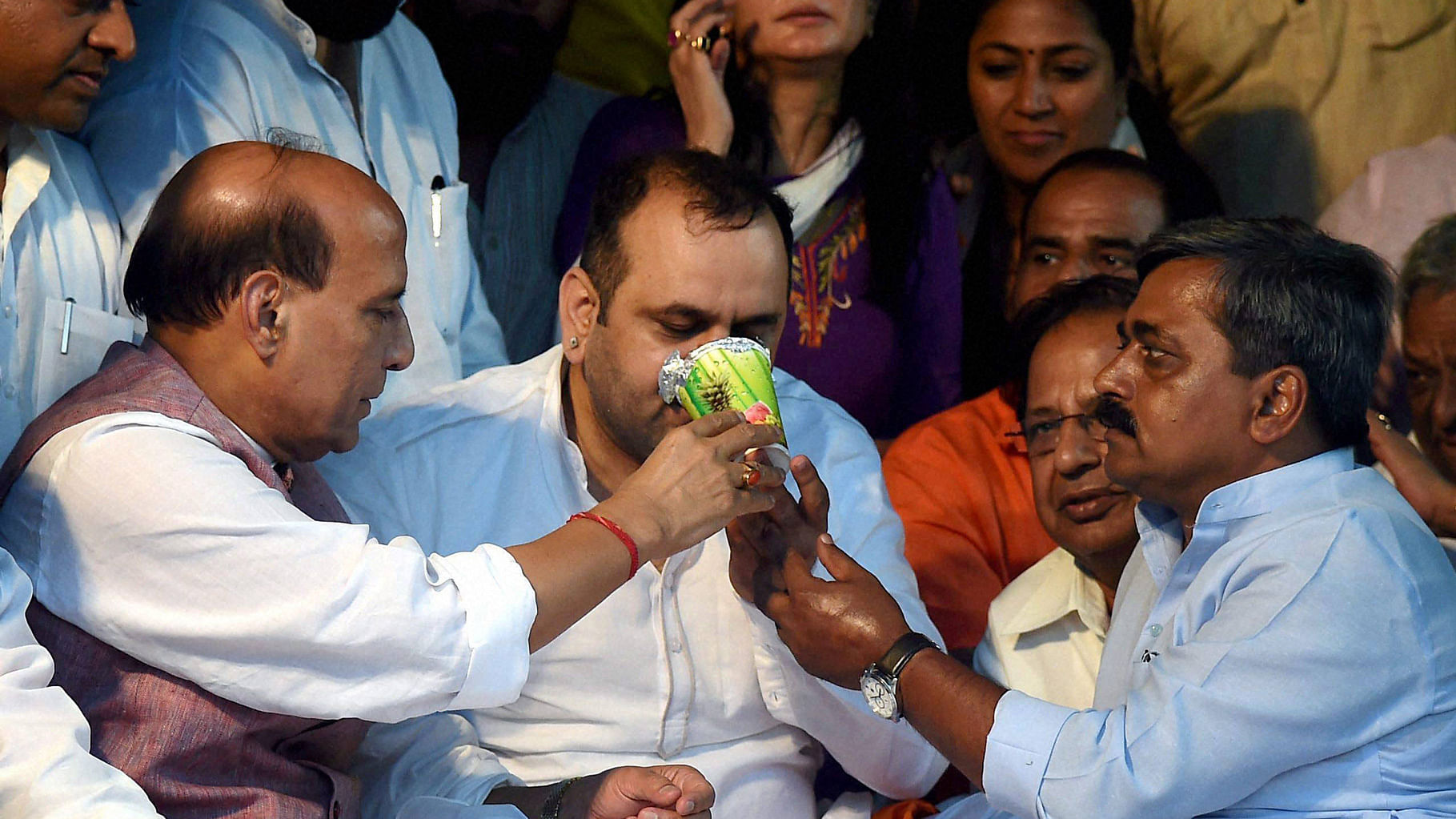  BJP MP Mahesh Giri breaks his fast in the presence of Home Minister Rajnath Singh and other BJP leaders in New Delhi on Tuesday. (Photo: PTI)