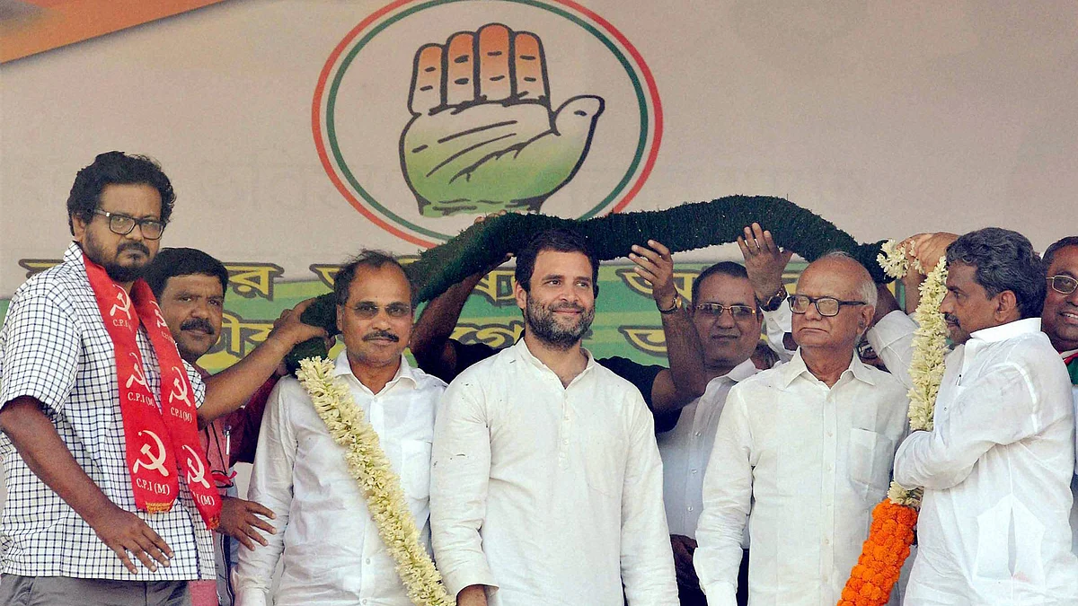Congress Vice-President Rahul Gandhi being garlanded by CPI(M)-Congress joint candidates Anjan Bera (L) and Santosh Pathak (R) during an election campaign rally in Howrah. (Photo: PTI) 