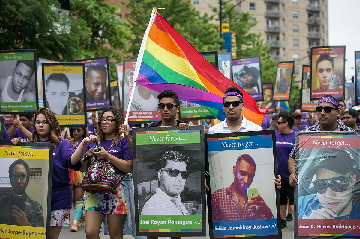 A group carried placards with photos of the Orlando victims. (Photo: AP)