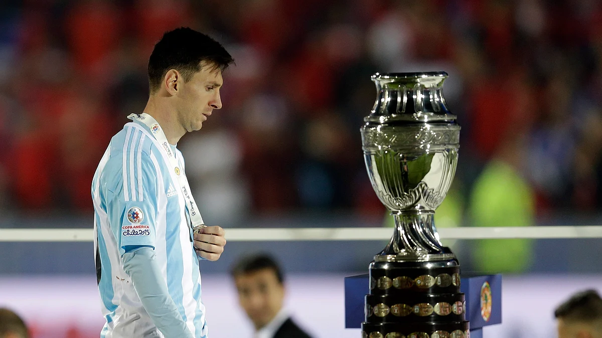 Lionel Messi takes a look at the winners trophy during the presentation ceremony. (Photo: AP)