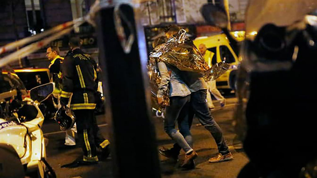 

A person being evacuated after a shooting outside the Bataclan theatre in Paris. (Photo: AP)