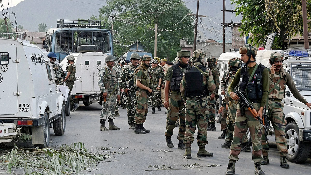 Army jawans stand guard after militants attacked a CRPF bus on the Srinagar-Jammu National High Way in Pampore, Srinagar. (June 25, 2016)