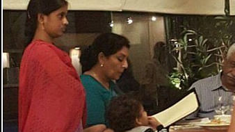 The girl was standing behind the family as they sat for their meal. (Photo: Twitter @rishibagree)