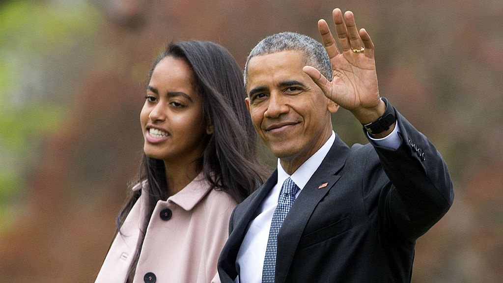 In this 7 April 2016 file photo, US President Barack Obama and his daughter Malia walk across the South Lawn of the White House in Washington (Photo: AP)  