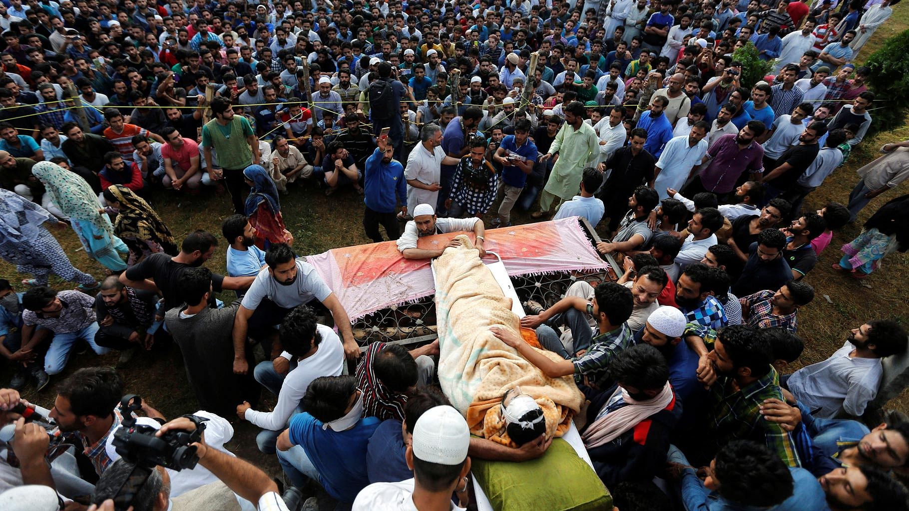 File photo of people in Kashmir attending Burhan Wani’s funeral after defying curfew. (Photo: Reuters)
