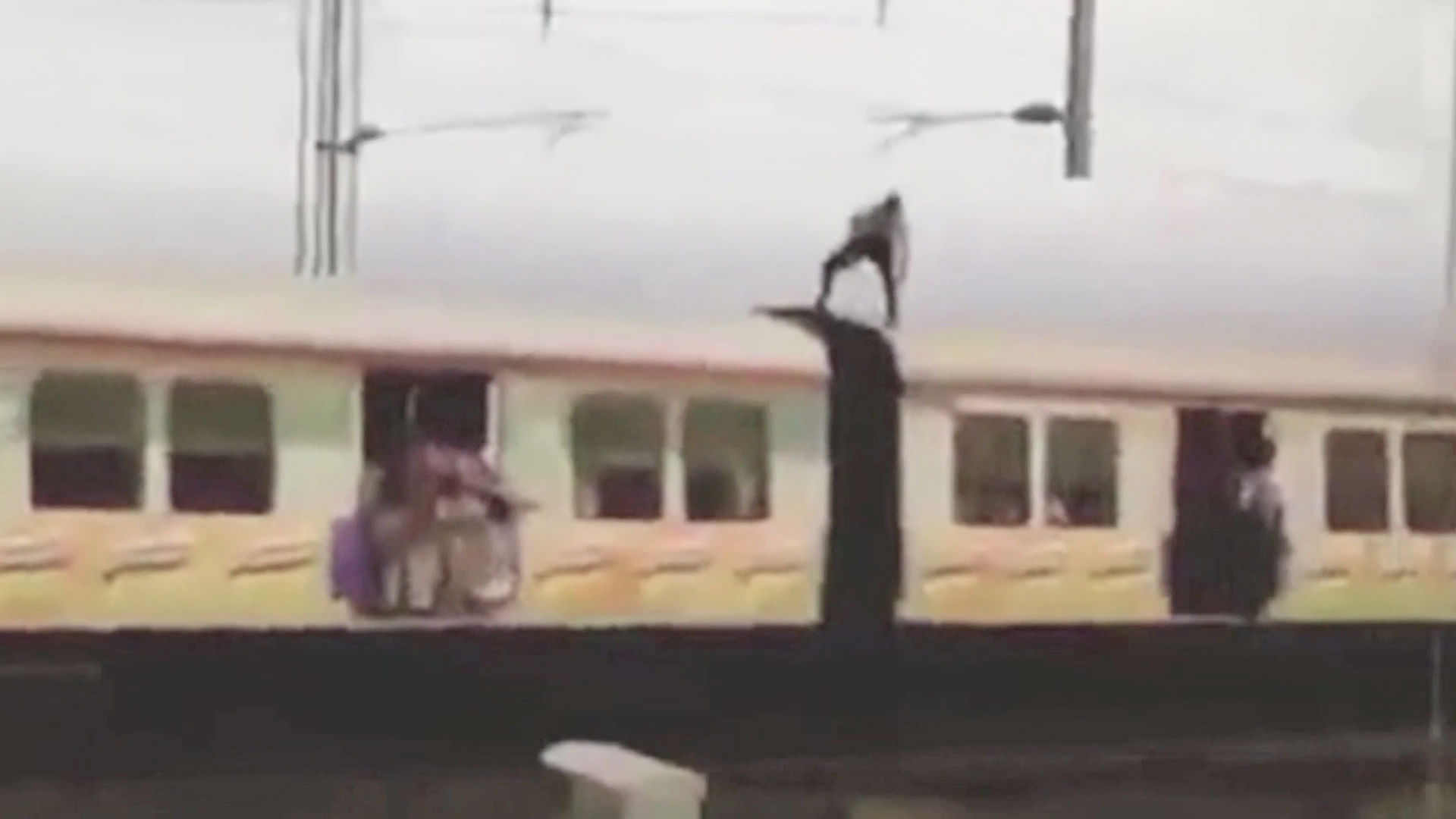 The man was dodging electrical cables as he stood on top of the moving train. (Photo: AP/Caters)