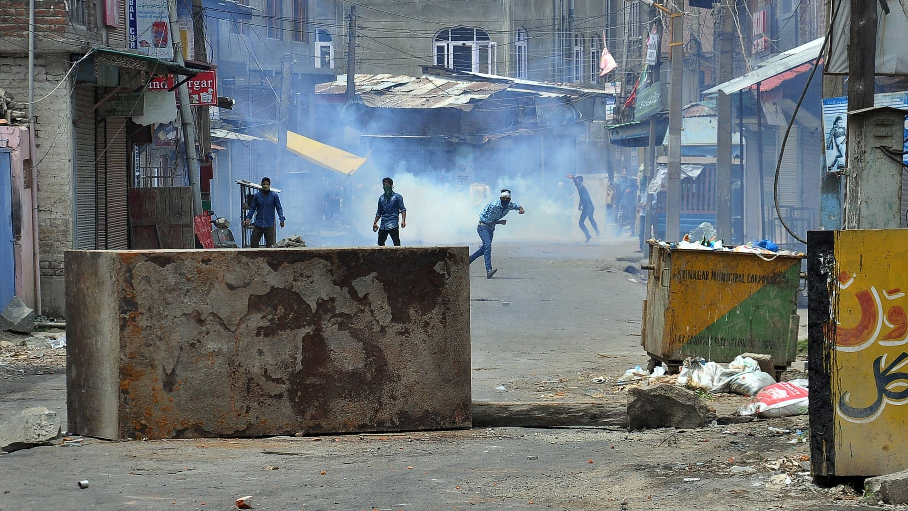

Youngsters pelt stones at poilcemen  in Srinagar on July 10, 2016. (Photo: IANS)