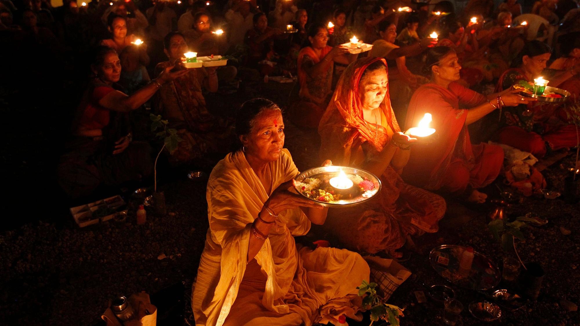People carry oil lamps as they pray for thousands of flood victims in Uttarakhand. (Photo: REUTERS/Amit Dave)