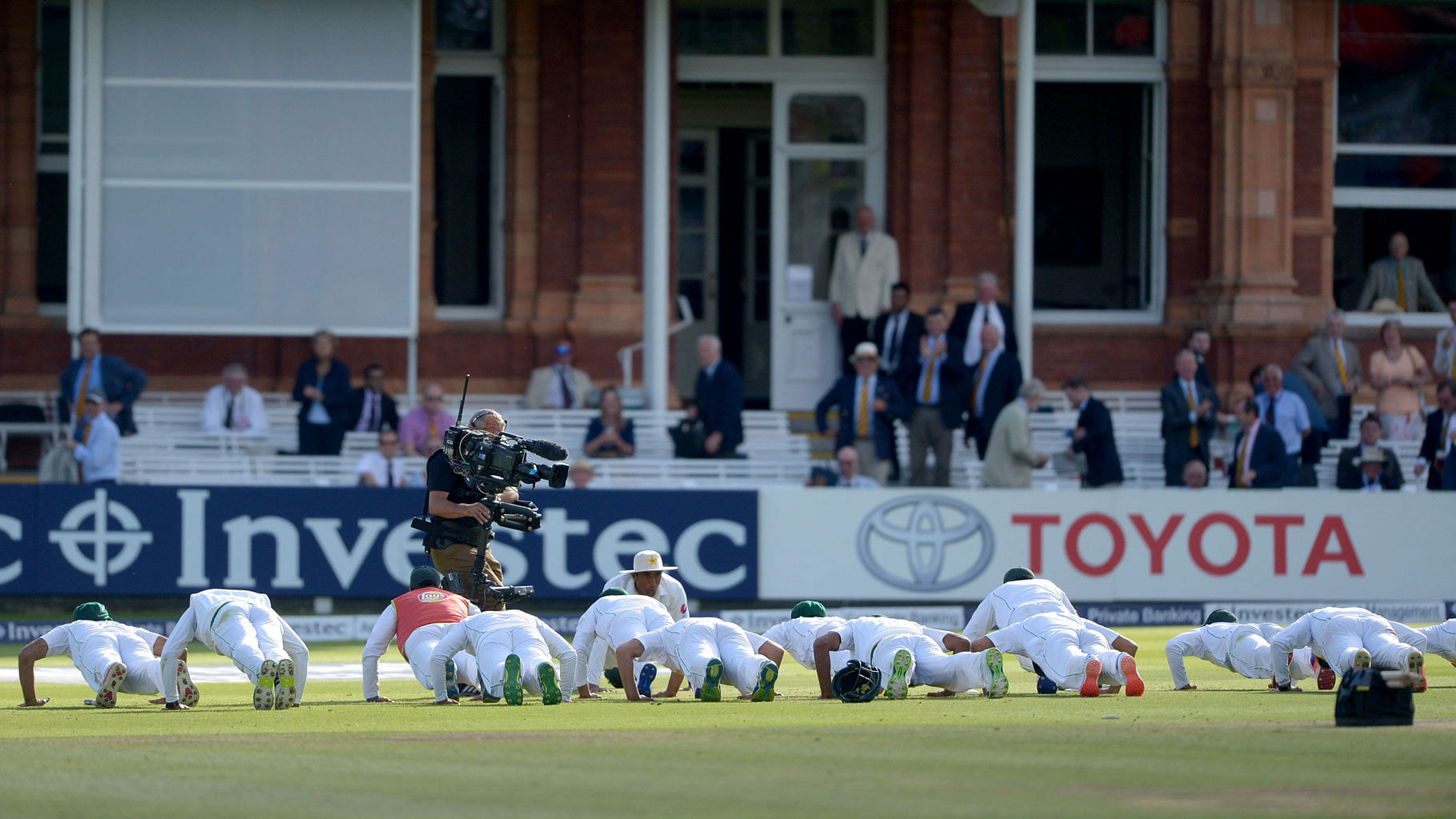 

The Pakistan team celebrate winning their match against England by doing push-ups on the pitch on day four of the cricket Test match at Lord’s. (Photo: AP)