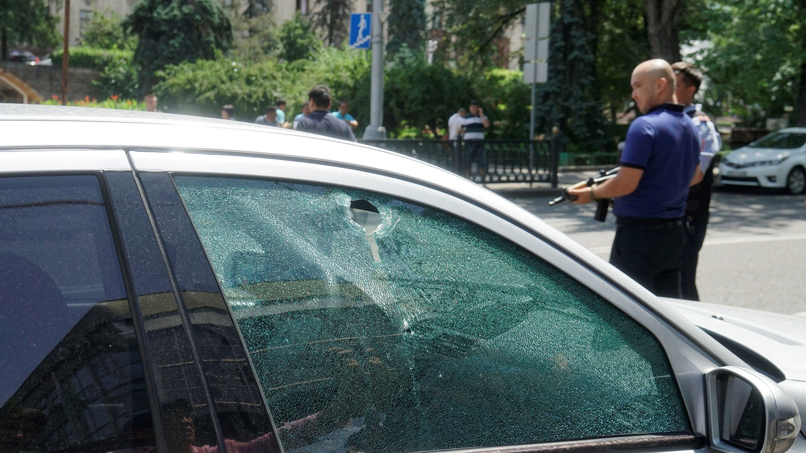 A bullet hole is seen on the window of a car parked in the street in Almaty, Kazakhstan. (Photo: Reuters) 