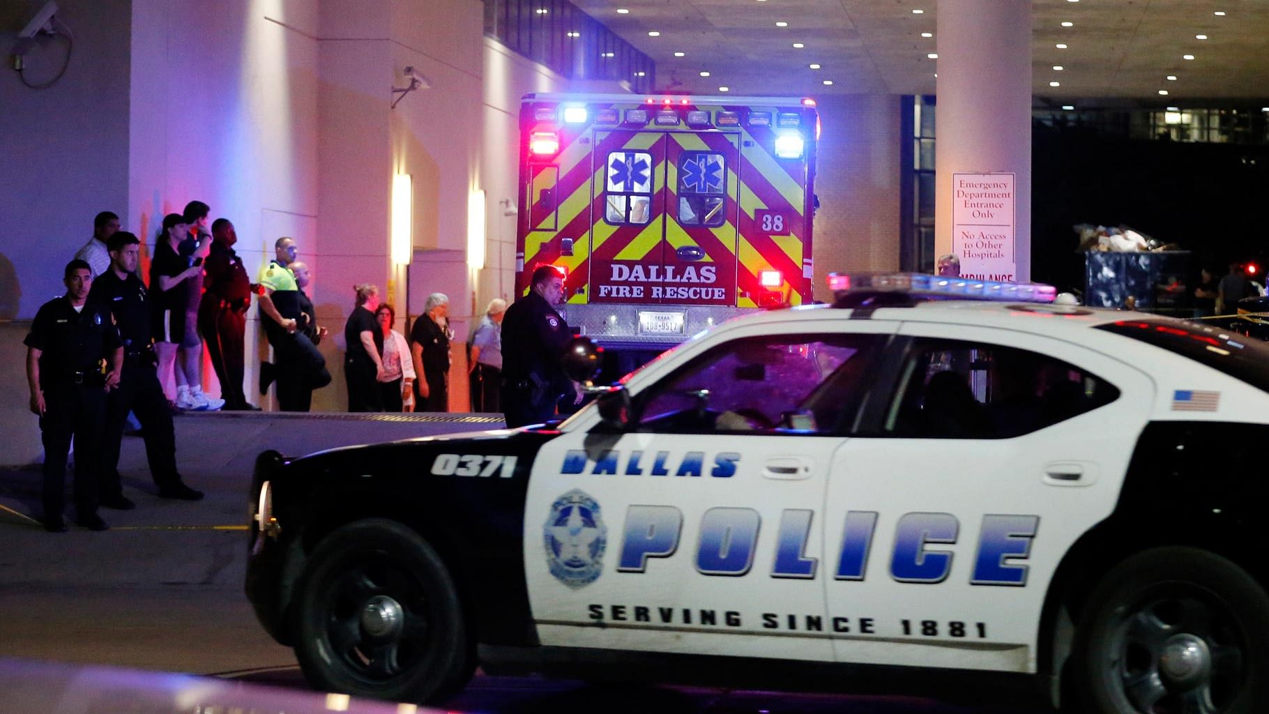 A Dallas police vehicle follows behind an ambulance carrying a patient to the Baylor University Medical Center on Friday, 8 July 2016. (Photo: AP)