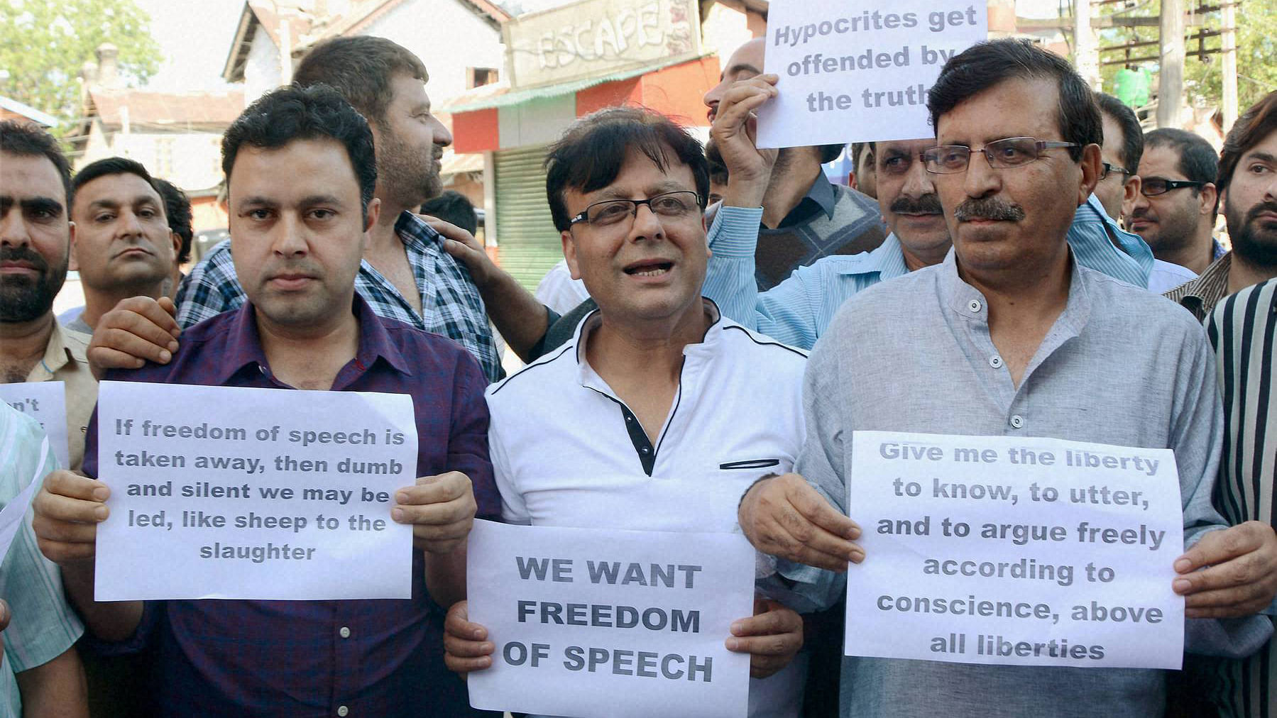 Senior journalists and editors of newspapers holding placards during a silent protest against the state government for continuous ban on media. (Photo: PTI)