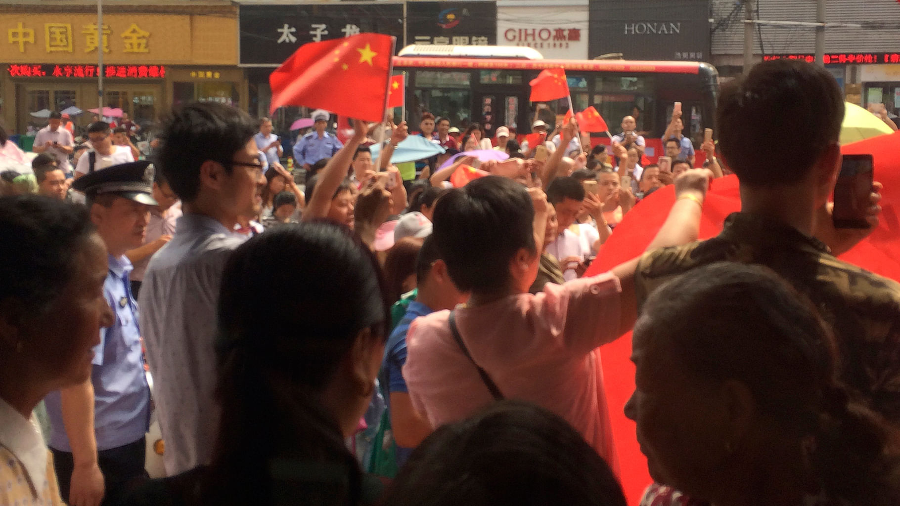  Chinese people carrying national flags hold a protest outside a KFC restaurant. (Photo: AP)
