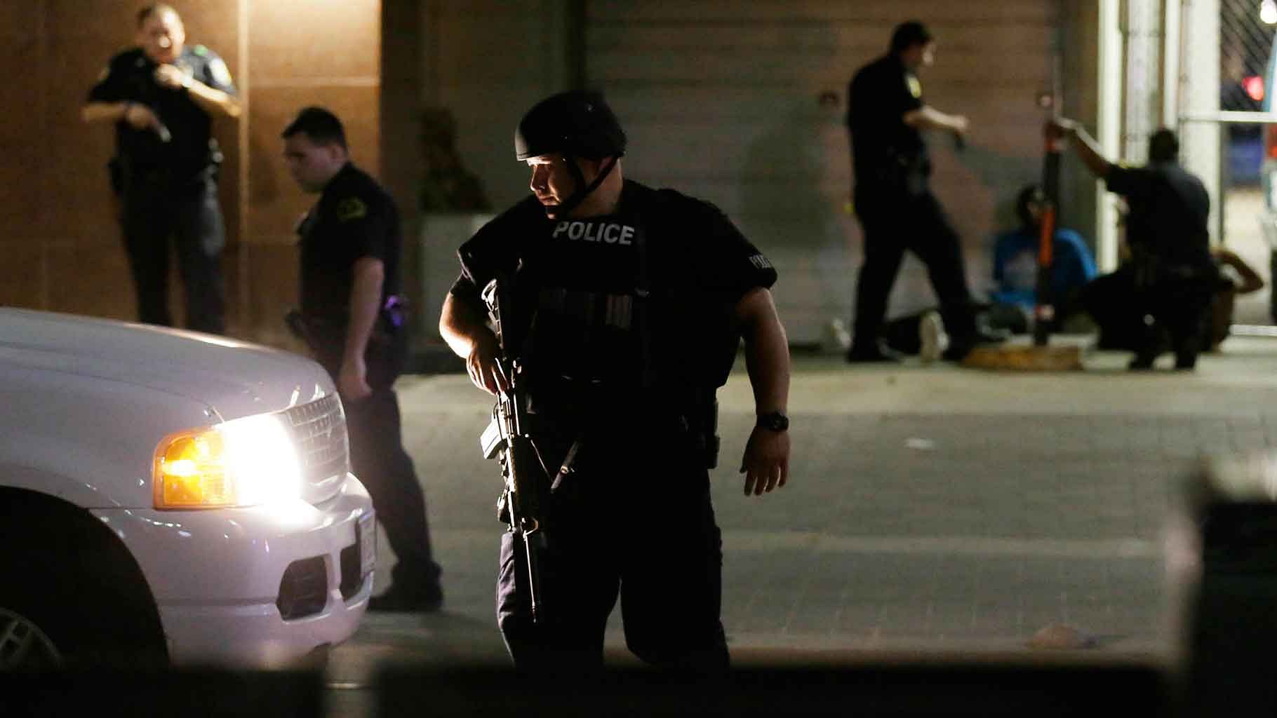 Dallas police detain a driver after several police officers were shot in downtown Dallas. (Photo: AP)