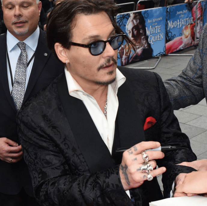 From “SLIM” to “SCUM”, Johnny Depp’s transforming tattoo tales.