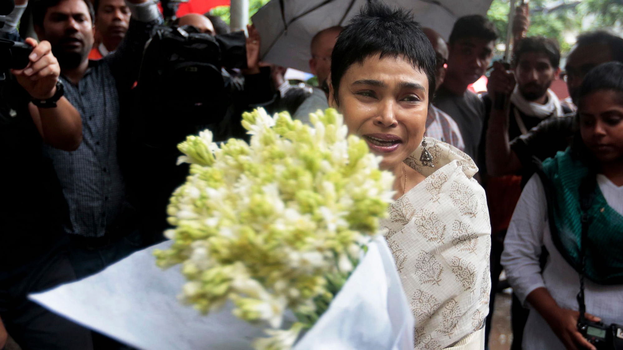 An unidentified woman cries as she brings flowers to pay respect to the victims of the attack. (Photo: AP)