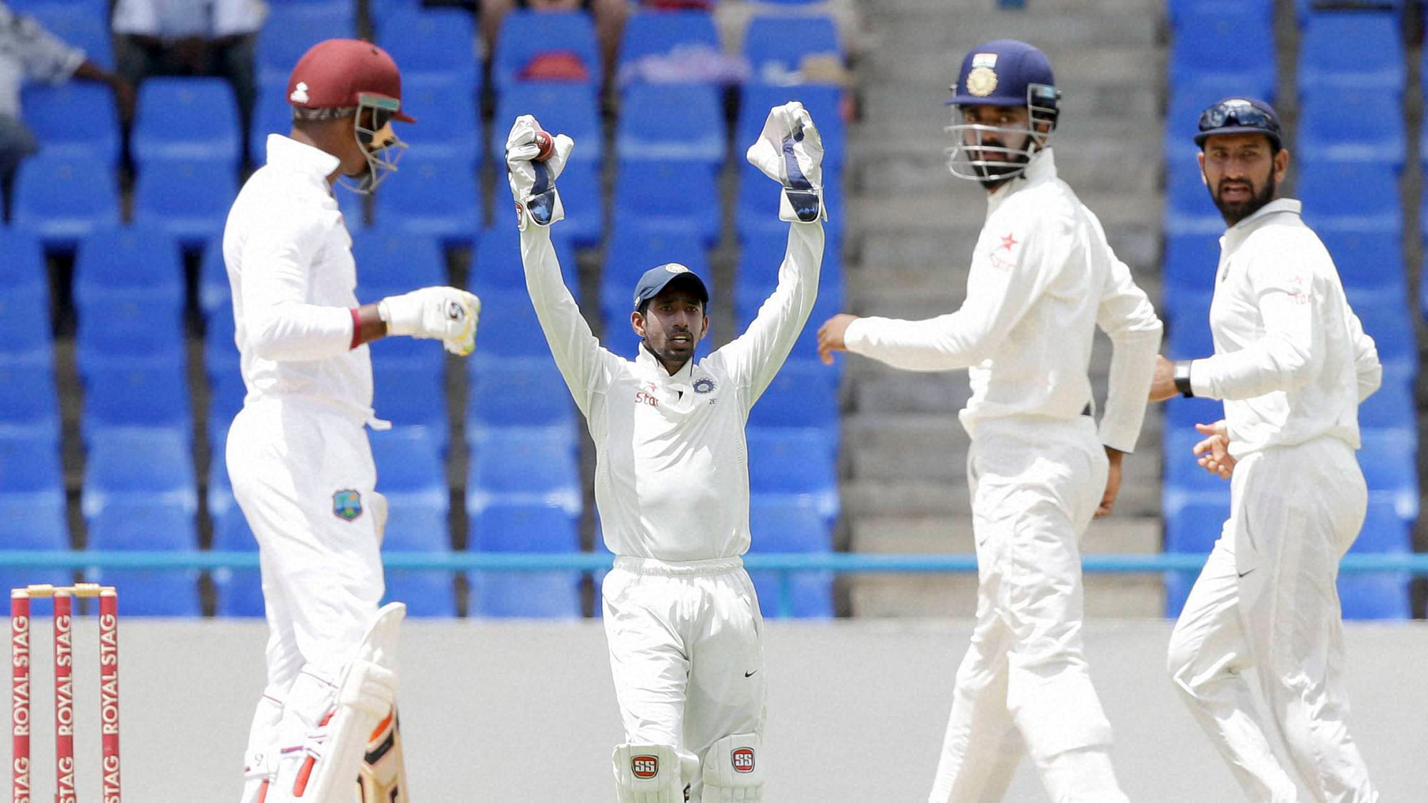 Indian wicket keeper Wriddhiman Saha appeals during day four in first Test Match at Antigua. (Photo: PTI)