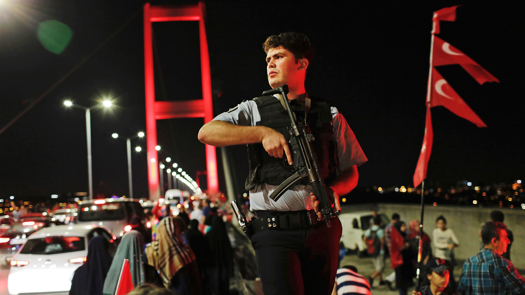 A Turkish police officer patrols as pro-government supporters gather on Istanbul’s iconic Bosphorus Bridge.(Photo: AP)