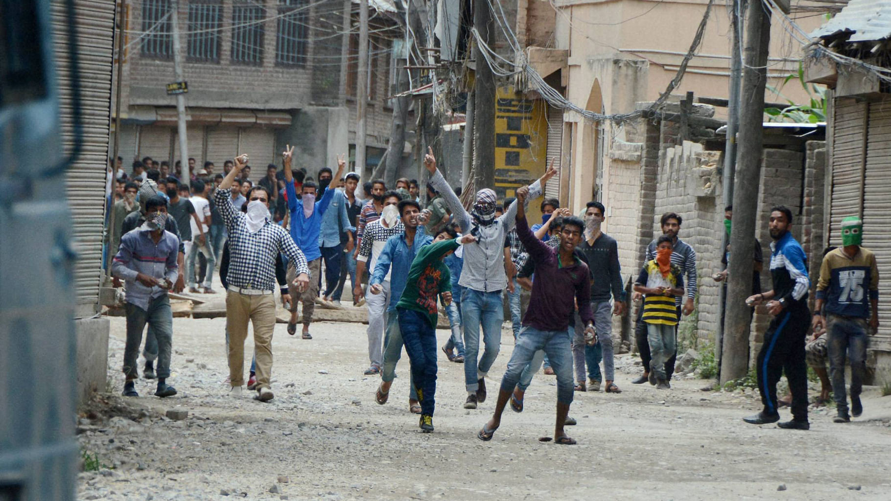 Protesters throwing stones on police vehicle during a protest following the killing of Hizbul Mujahideen commander Burhan Muzaffar Wani along with his two associates, in Srinagar on Saturday. (Photo Courtesy: PTI)