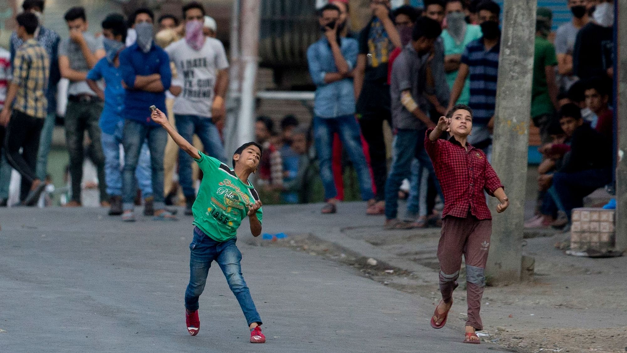 

Young Kashmiri protesters throw bricks and rocks at Indian securitymen during a protest in Srinagar, Indian controlled Kashmir, Saturday, July 16, 2016. (Photo: AP)