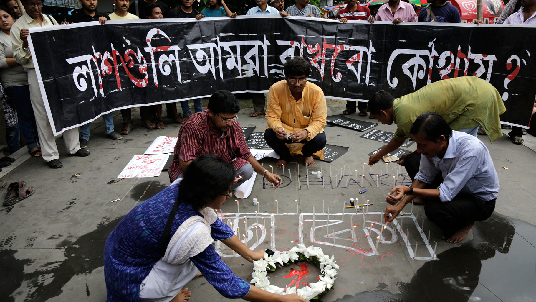 Indian activists participate in a candle light vigil protesting the Bangladesh restaurant attack, in Kolkata. (Photo: AP)