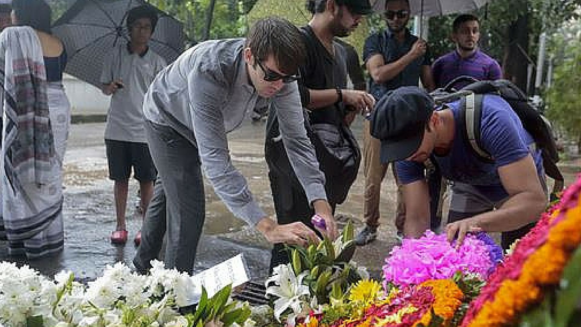 People offer flowers to pay their respects to the victims of the attack on Holey Artisan Bakery, in Dhaka, Bangladesh, Tuesday, July 5, 2016. (Photo: AP)