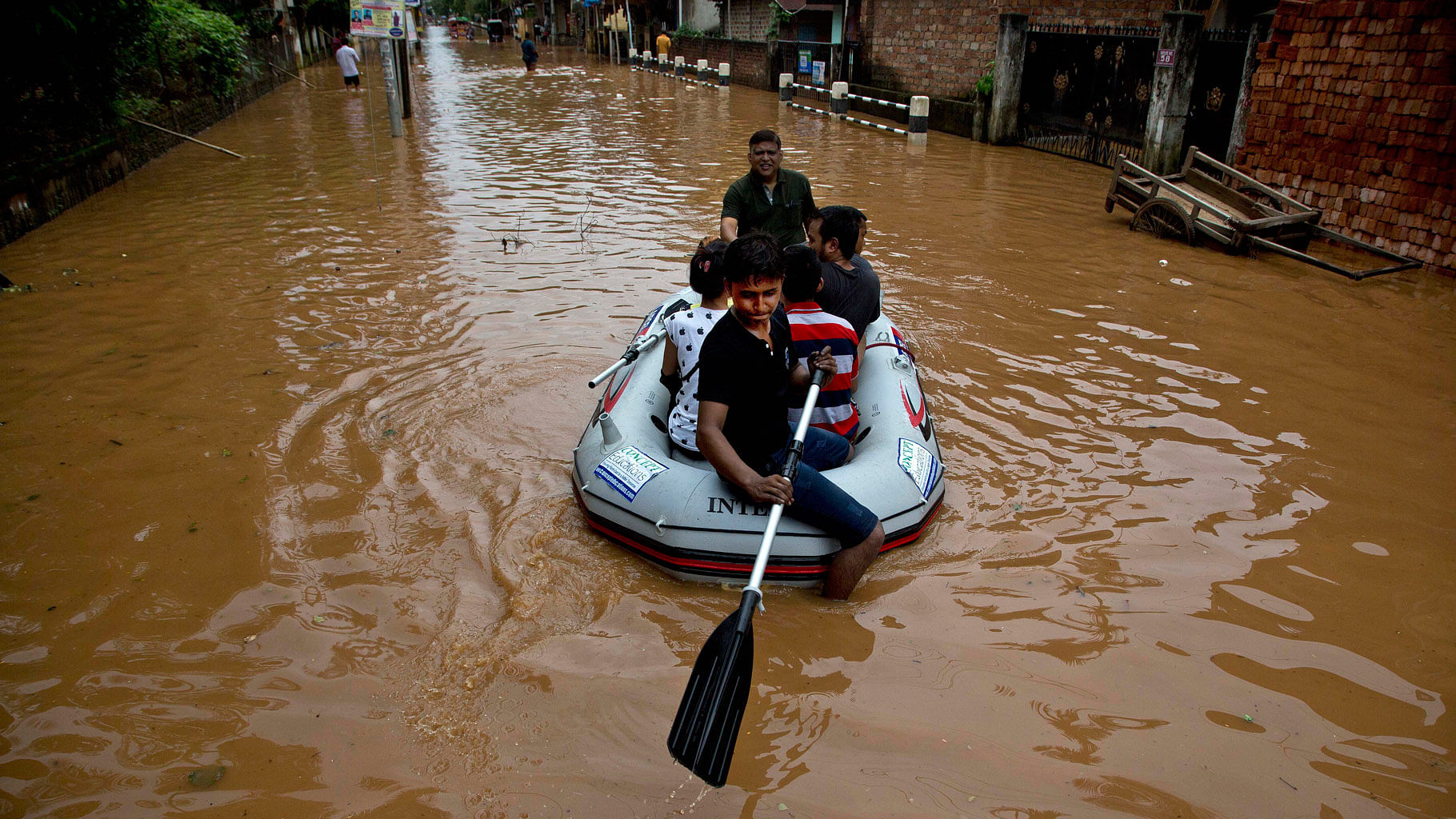 

Volunteers shift people to higher areas after heavy monsoon rains flooded parts of Gauhati. (Photo: AP)