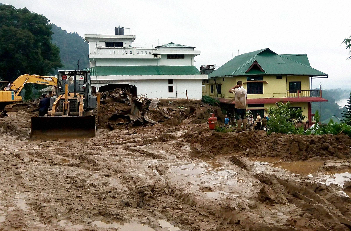 Workers busy in cleaning the debris of massive landslide that buried several houses at Bhalukpong in Arunachal Pradesh on Friday. (Photo: PTI) 