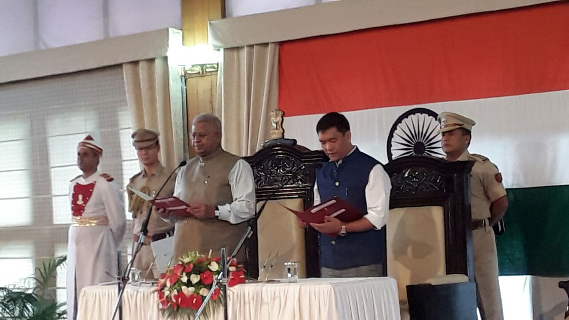 Pema Khandu, the country’s youngest chief minister, being sworn in by Governor Tathagata Roy. (Photo Courtesy: Anjana Dutta)