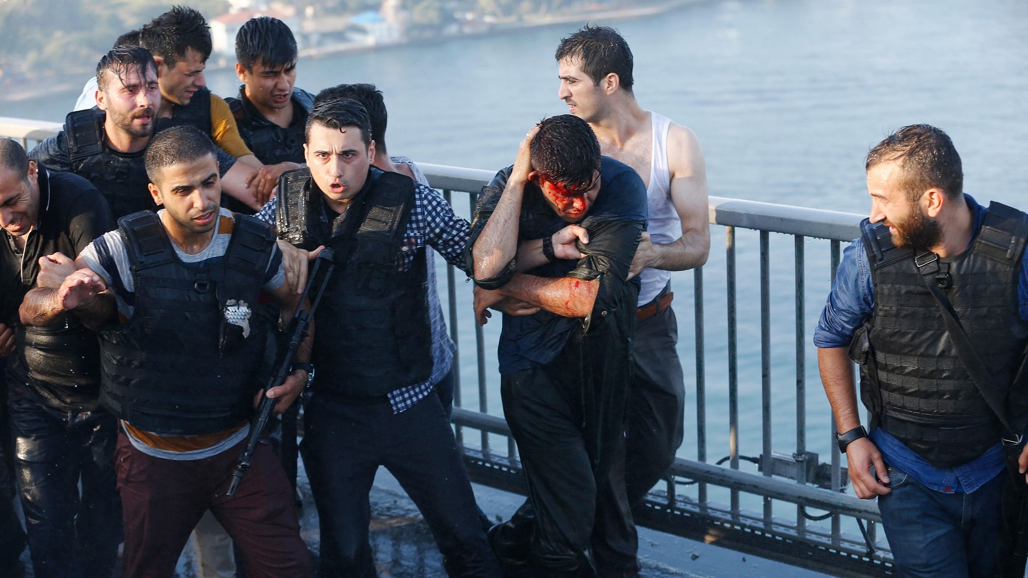 Policemen protect a soldier from the mob after troops involved in the coup surrendered on the Bosphorus Bridge in Istanbul, Turkey. (Photo: Reuters)