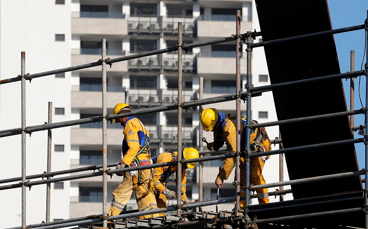 Workers at a construction site in Olympic Village. (Photo: Reuters)
