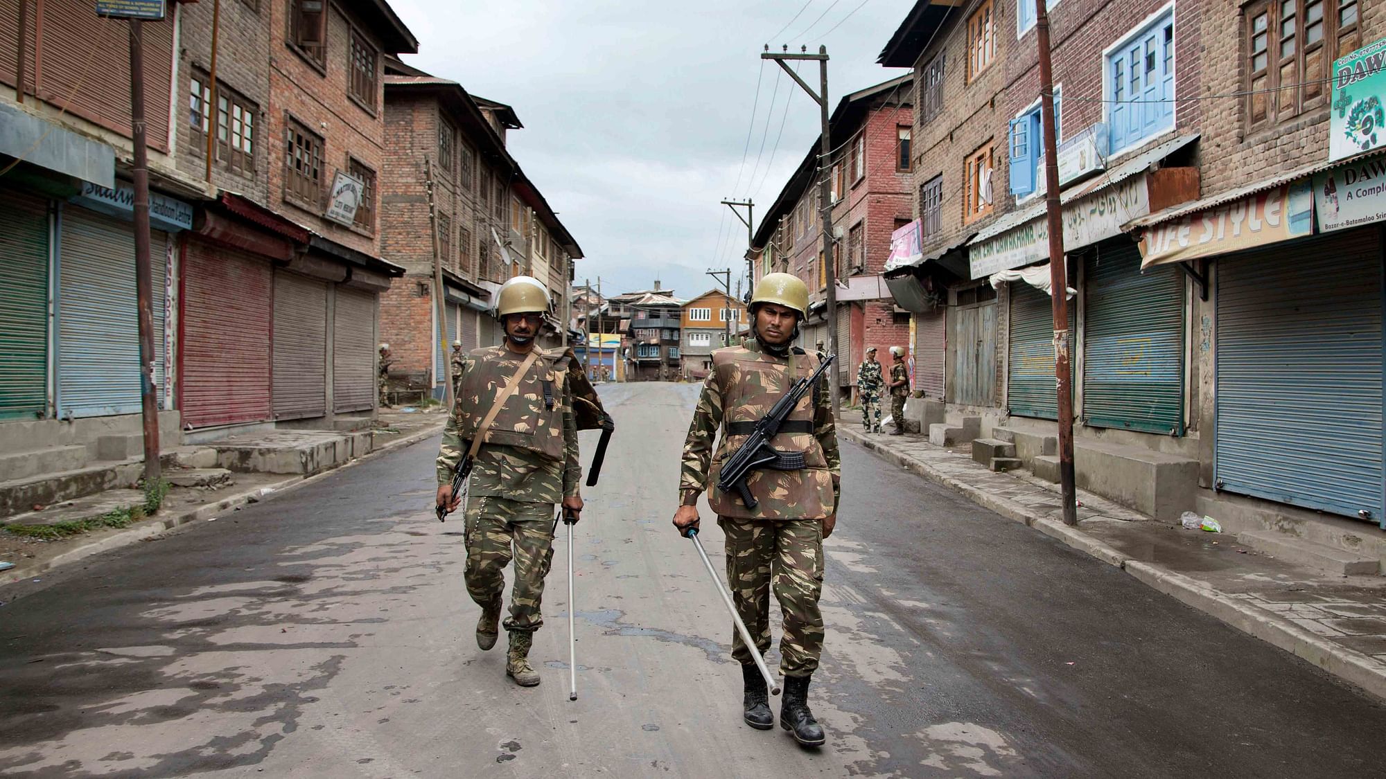 Indian paramilitary soldiers patrol a neighborhood during a  curfew in Srinagar.&nbsp;