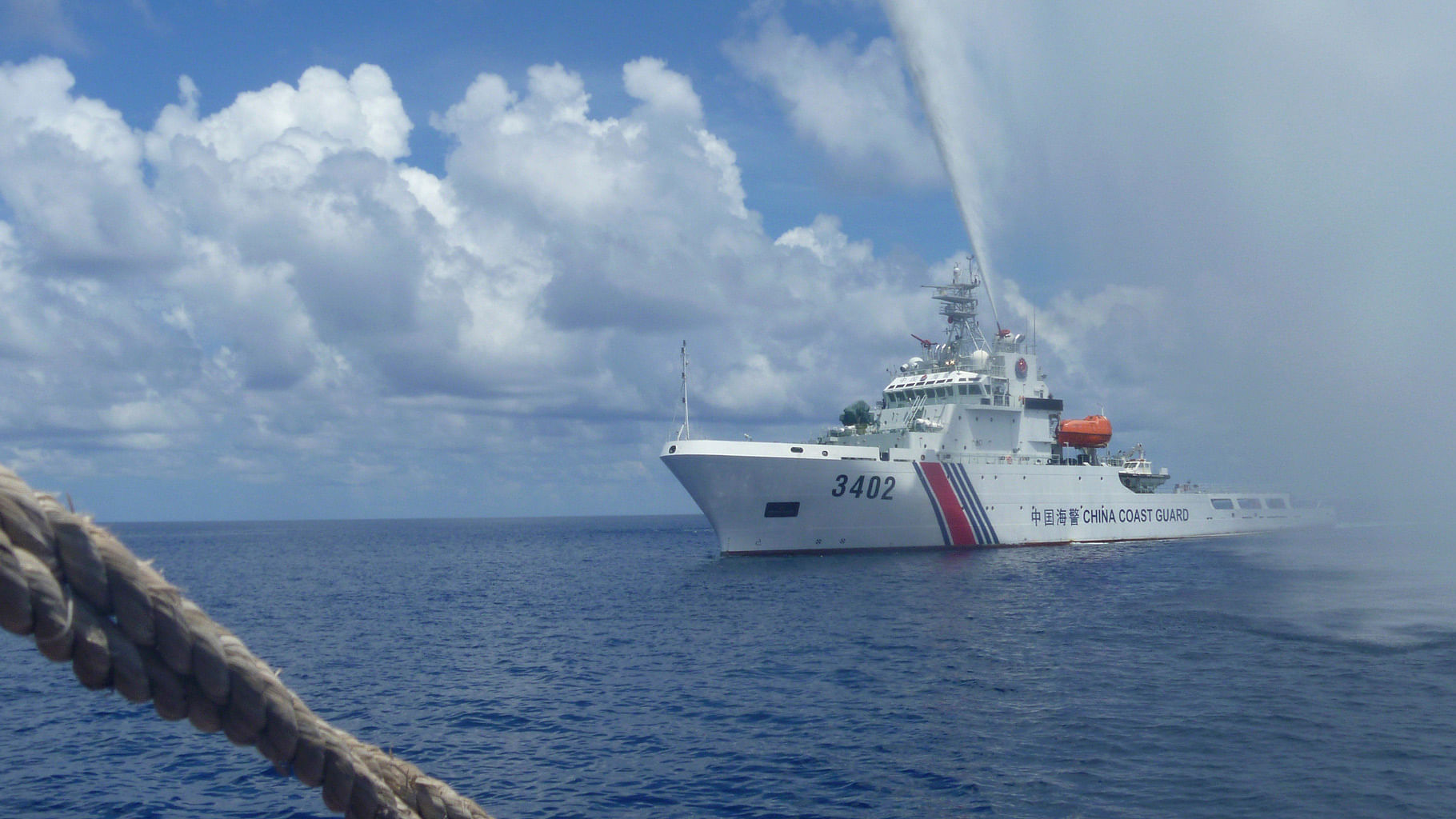 Chinese Coast Guard members approach Filipino fishermen as they confront each other off Scarborough Shoal in the South China Sea. (Photo: AP)