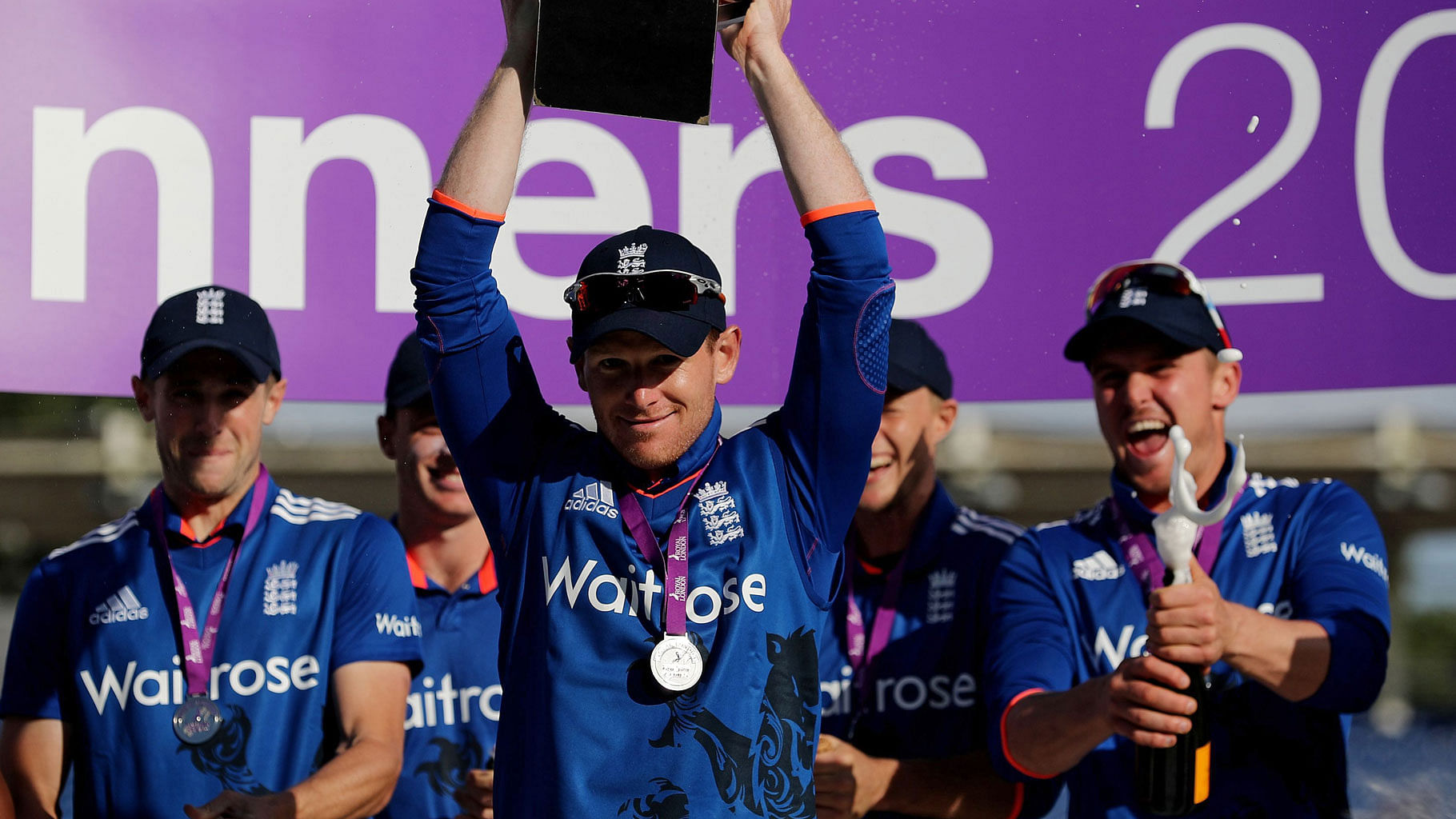 England’s captain Eoin Morgan, center, lifts the Royal London One Day series trophy. (Photo: AP)