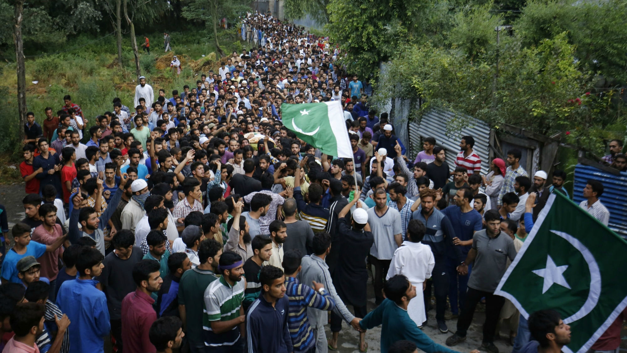People attend funeral procession of militant Burhan Wani at his village in Tral of Jammu and Kashmir’s Pulwama district on 9 July. (Photo: IANS)