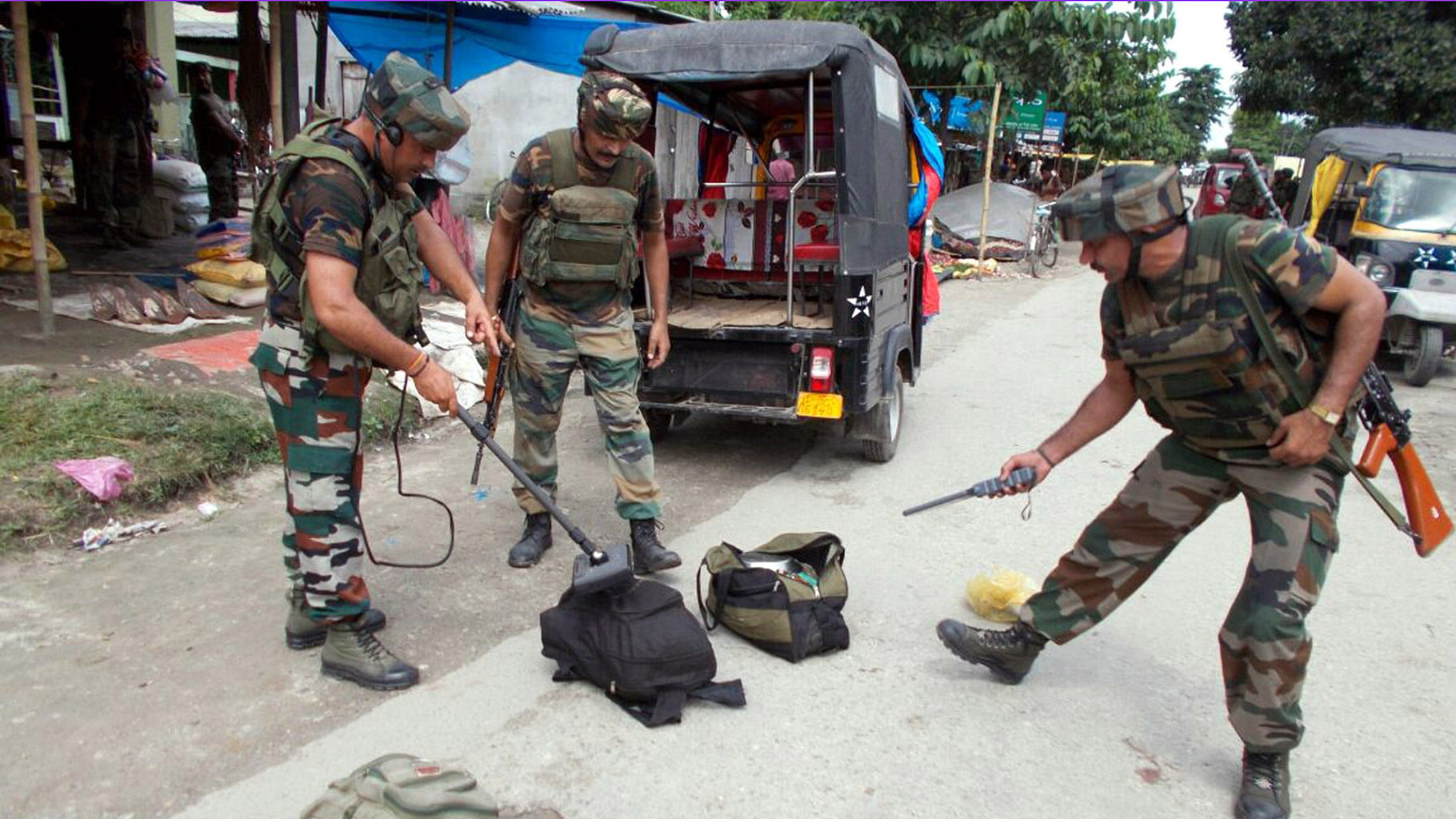 

Army personnel check bags left by a group of militants after the Kokrajhar terror attack. (Photo: IANS)