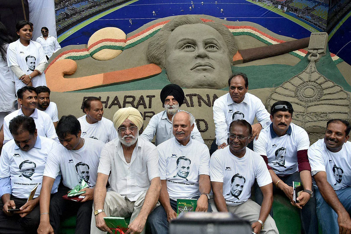 Former hockey players sitting at a demonstration in front of a sand image to demand Bharat Ratna honour for hockey legend Dhyan Chand, at Jantar Mantar in New Delhi on Sunday. 