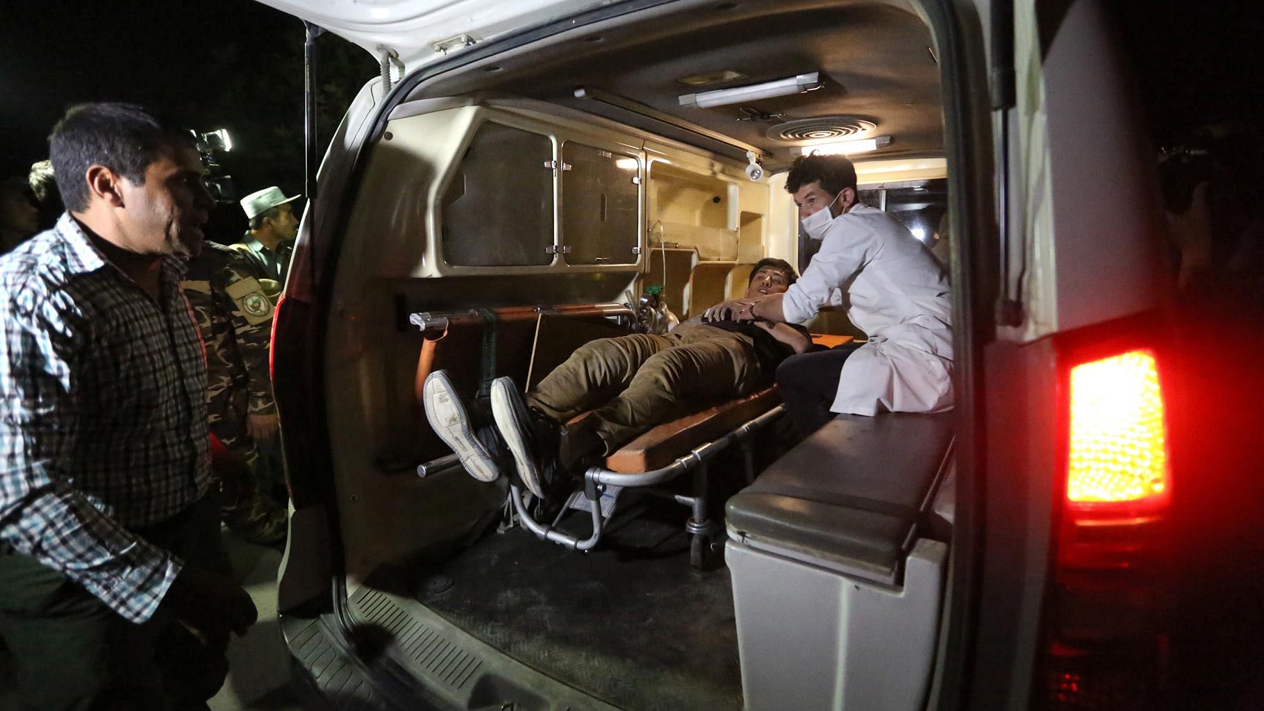 A man wounded is assisted in an ambulance after a complex Taliban attack on the campus of theAmerican University in the Afghan capital Kabul on Wednesday. (Photo: AP)