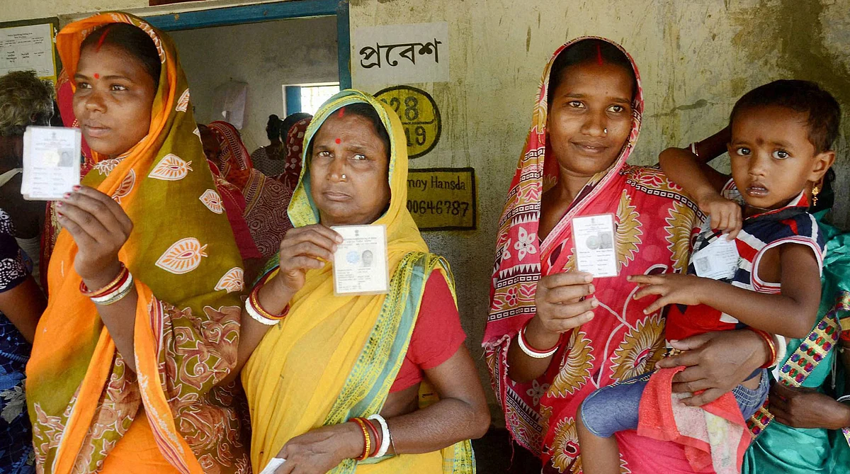 Women show their voter cards before casting votes at a polling booth during the assembly elections in Kharagpur, West Bengal, April 2016. (Photo: PTI)